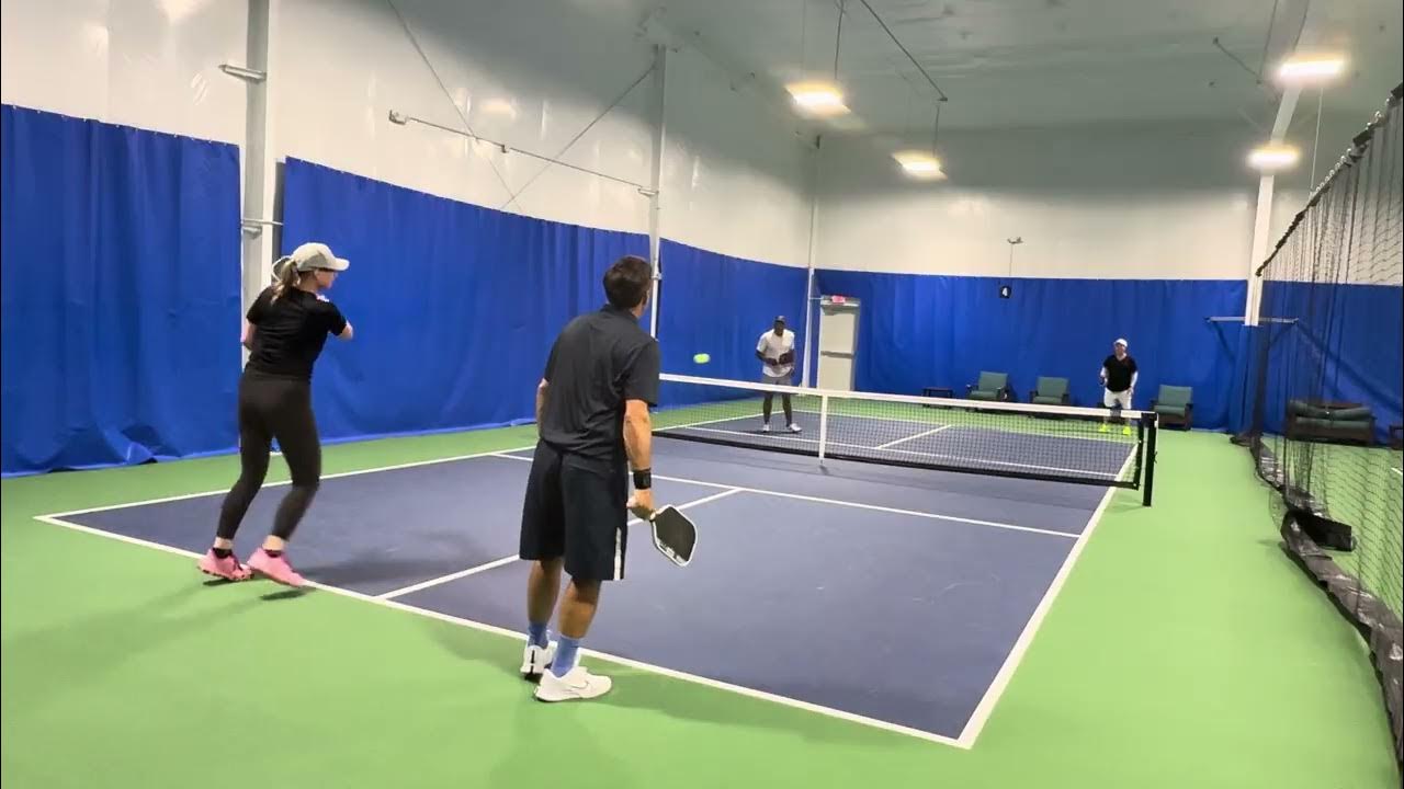 Mixed doubles rally on an E.H. indoor court